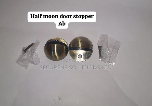 Bronze-Finished Ab Half-Moon Door Stoppers.