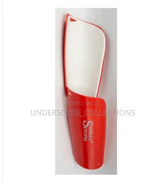 Red and White Striker Sports Shin Guards Designed to Protect Players