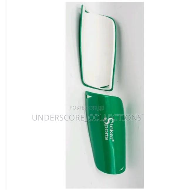 Green and White Striker Sports Shin Guards Designed to Protect Players