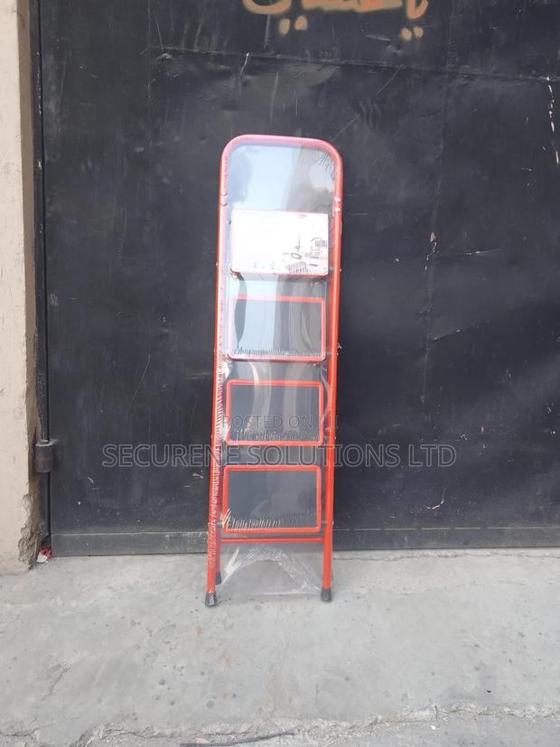 A 4-Step Foldable Steel Ladder With a Red Frame - main view