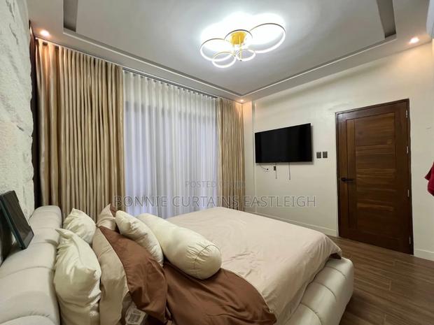 Gold Curtains and White Sheers With Hooks