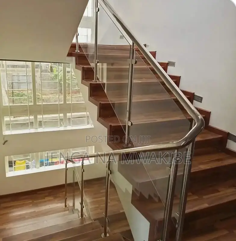 Clear Glass Balustrade And A Dark Wood Handrail Installation