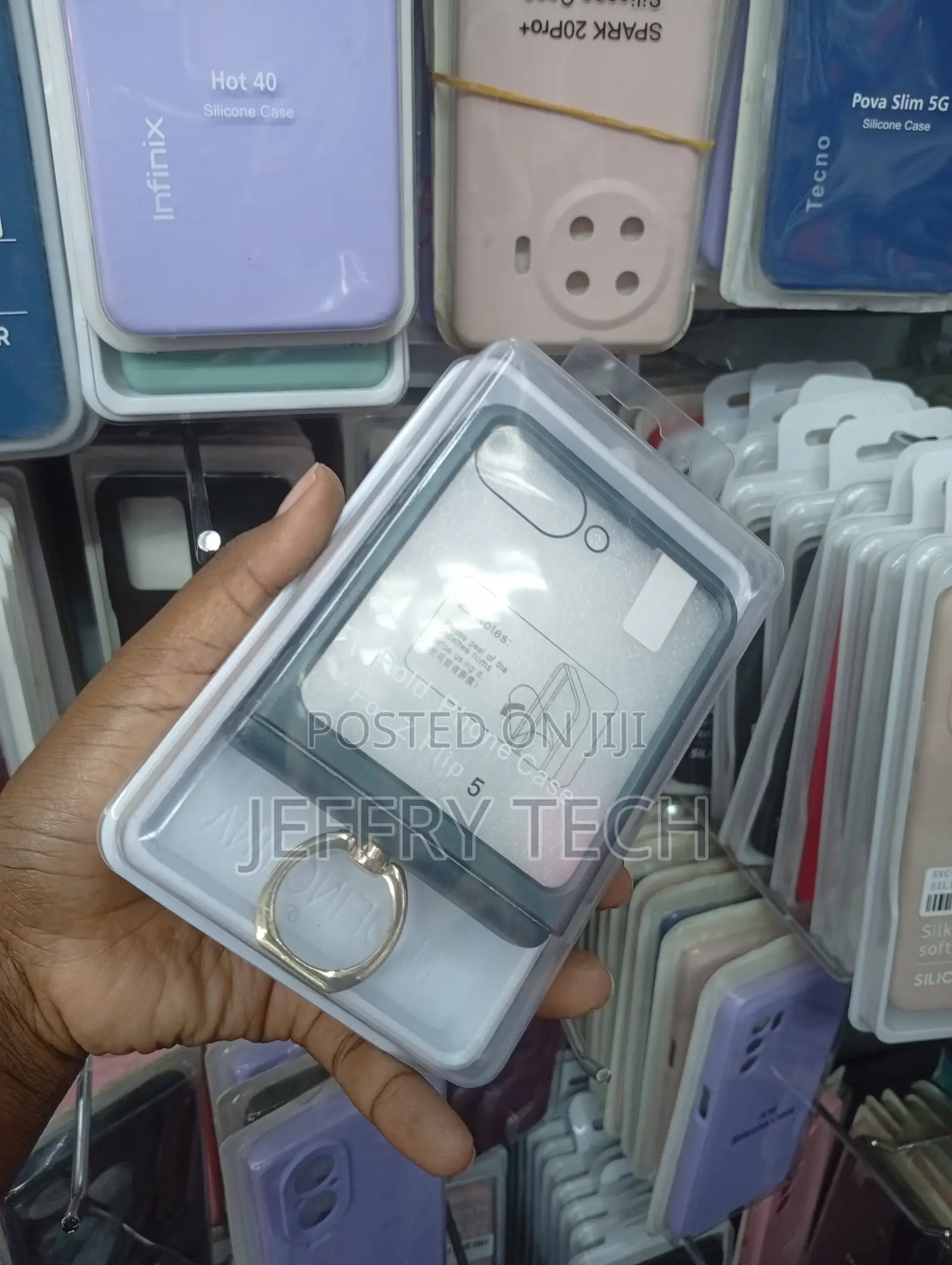 Samsung Galaxy Z Flip 5 With a Dark Grey Border and a Ring Holder.