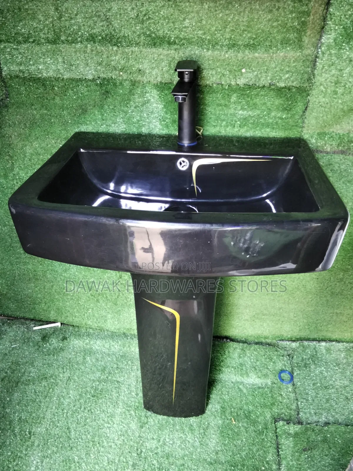 Black Designed Washhandbasin With a Gold Strip