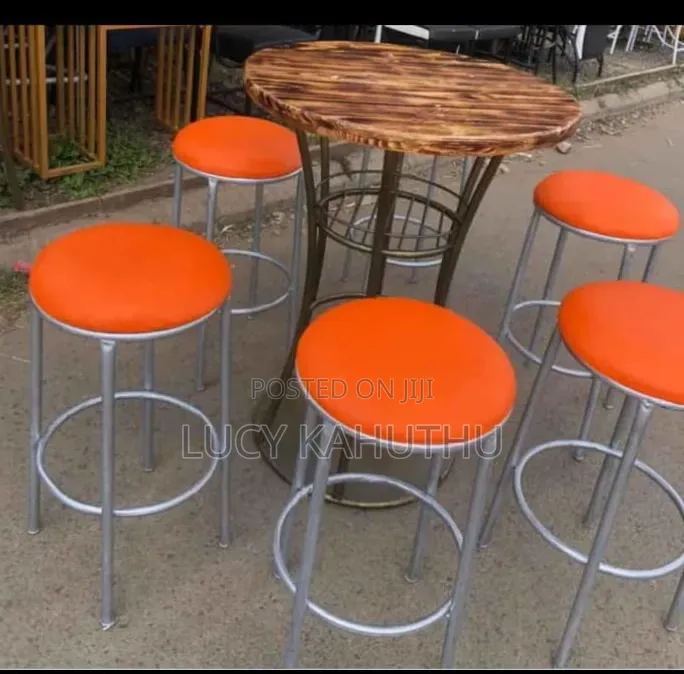 Polished Wood Table With Orange Stools