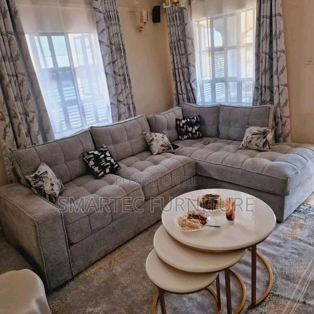 Gray L-Shaped Tufted Sectional Sofa With Patterned Pillows - main view