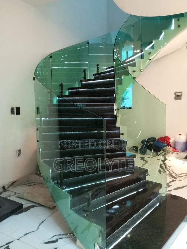 This Modern Helical Staircase and a Curved Glass Balustrade.