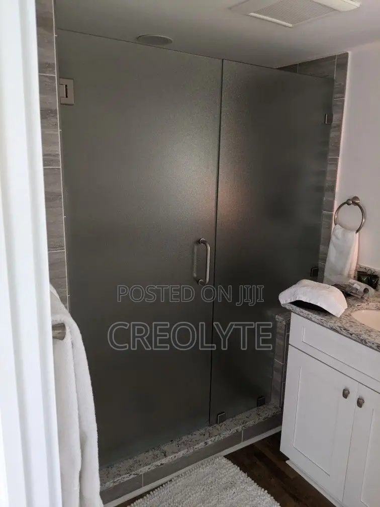 This Frameless Hinged Shower Door Features Frosted Glass