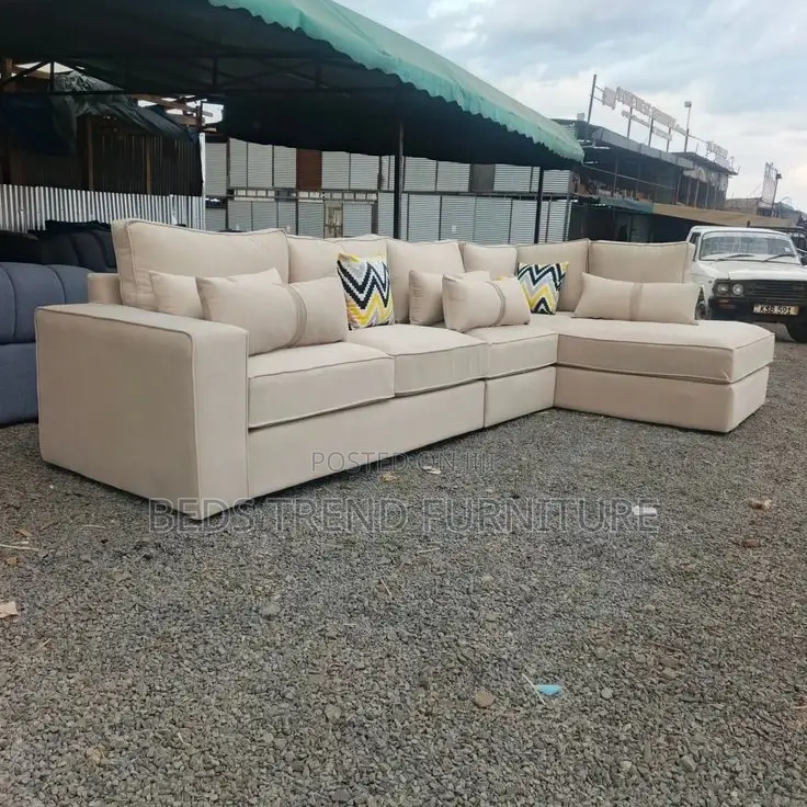 Beige L-Shaped Sofa With Cushions