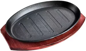 Cast Iron Hot Sizzling Plate With a Wooden Tray