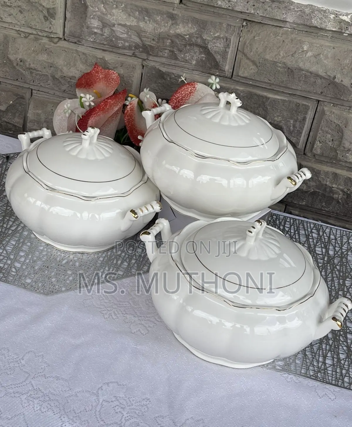 White Ceramic Serving Dishes With Gold-Rimmed Detailing and Handles.