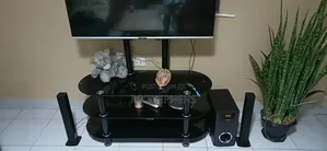 Sleek 3-Tier Black Tempered Glass Tv Stand With Integrated Mount