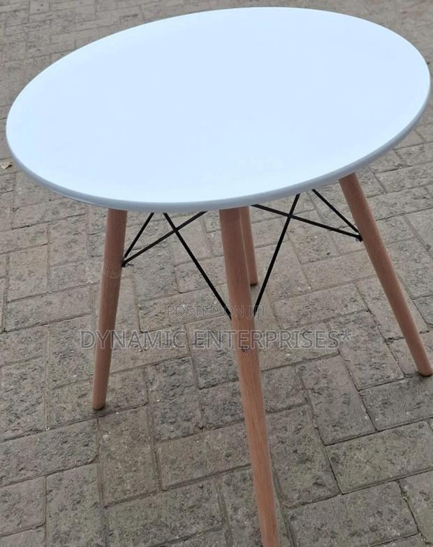 Dining Table Features a Smooth, Matte White Top