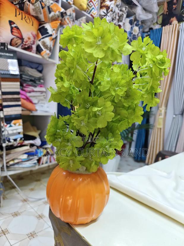 Artificial Green Flower in an Orange Vase