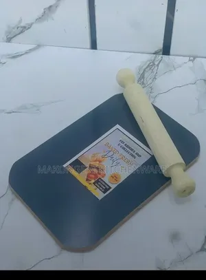 Blue Cutting Board Paired With a Wooden Rolling Pin.