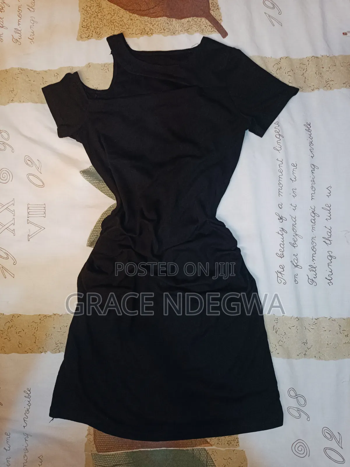 Black Mini Dress With Ruched Sides and an Off Shoulder.