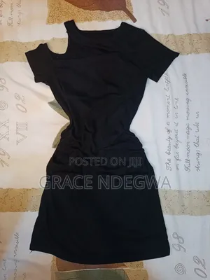 Black Mini Dress With Ruched Sides and an Off Shoulder.