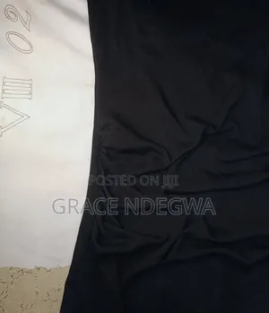 Black Mini Dress With Ruched Sides and an Off Shoulder.