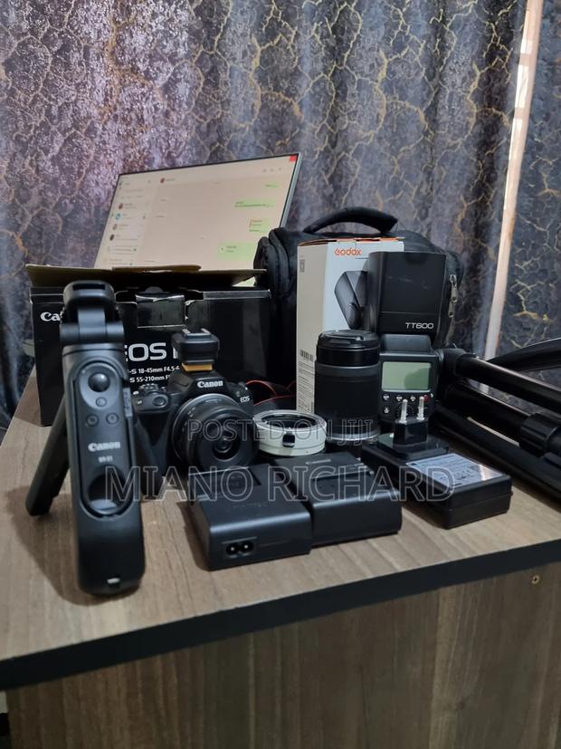 A Barely Used Canon Eos R50, Speedlite,Tripod.