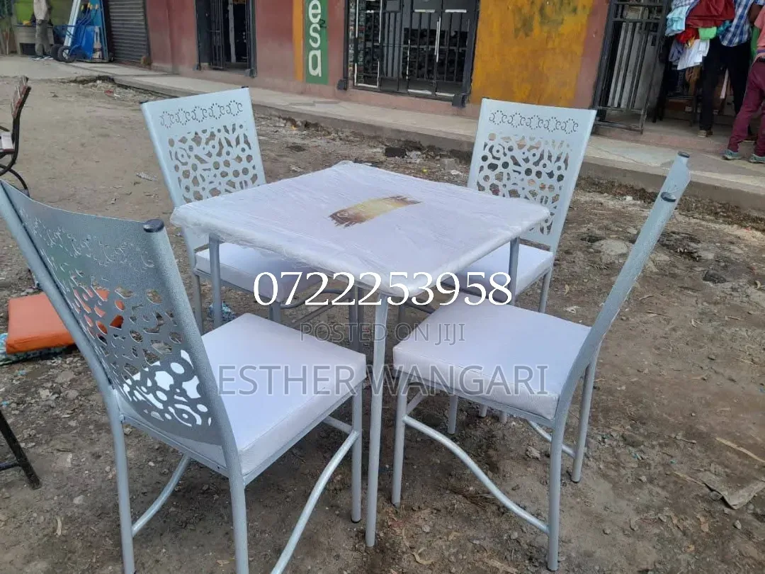 A Set of White Hotel Chairs and a Table
