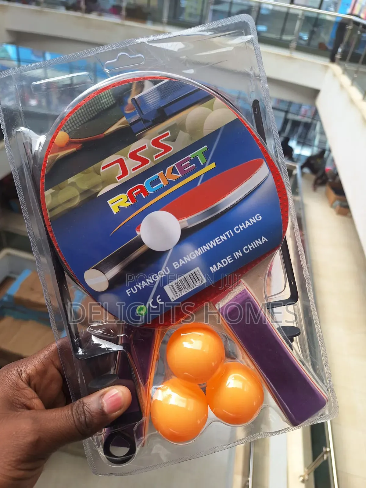 Two Rackets and Three Orange Balls