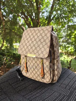 Retro-Style Unisex Backpack Features a Monogram Printed Material