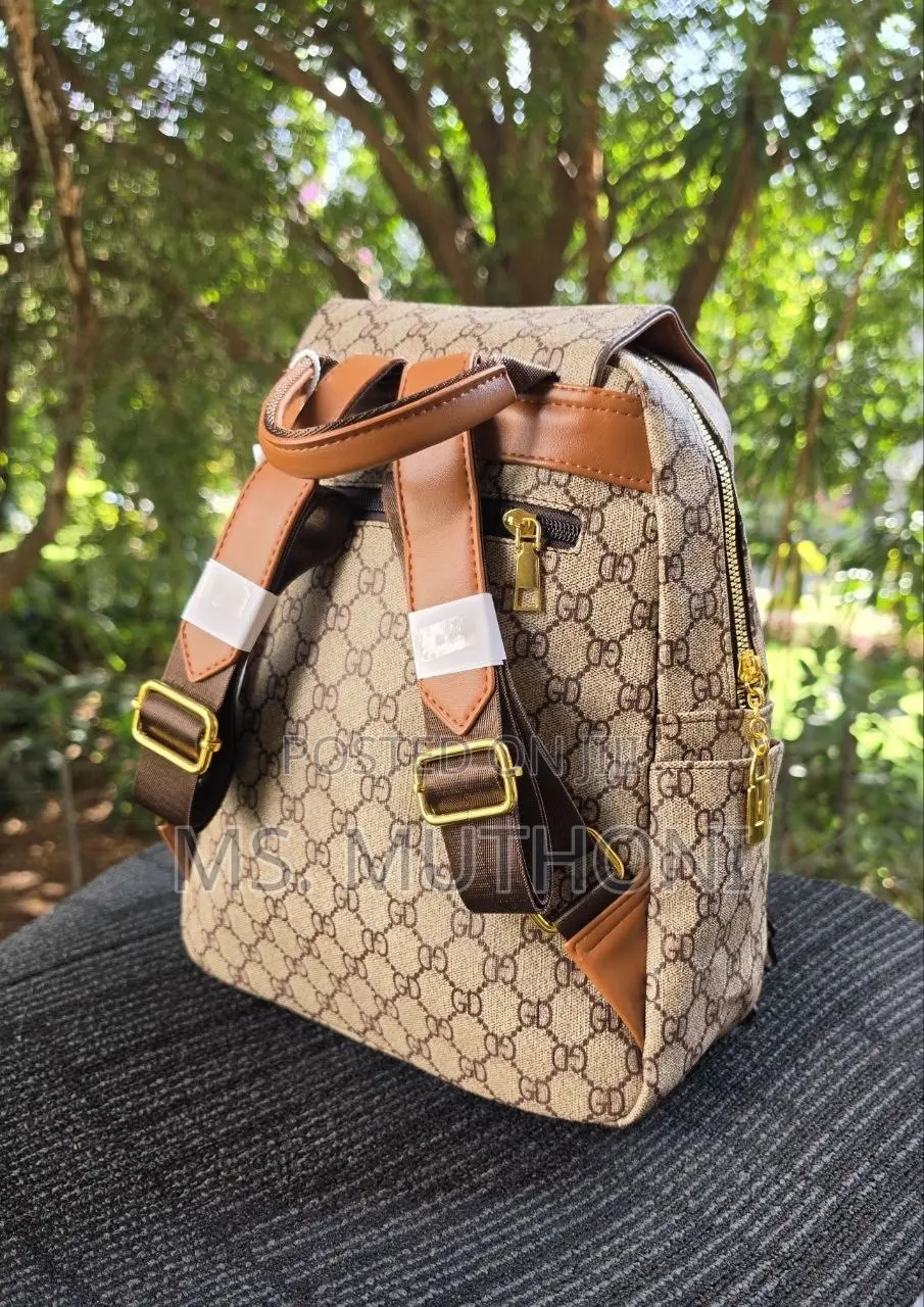 Retro-Style Unisex Backpack Features a Monogram Printed Material