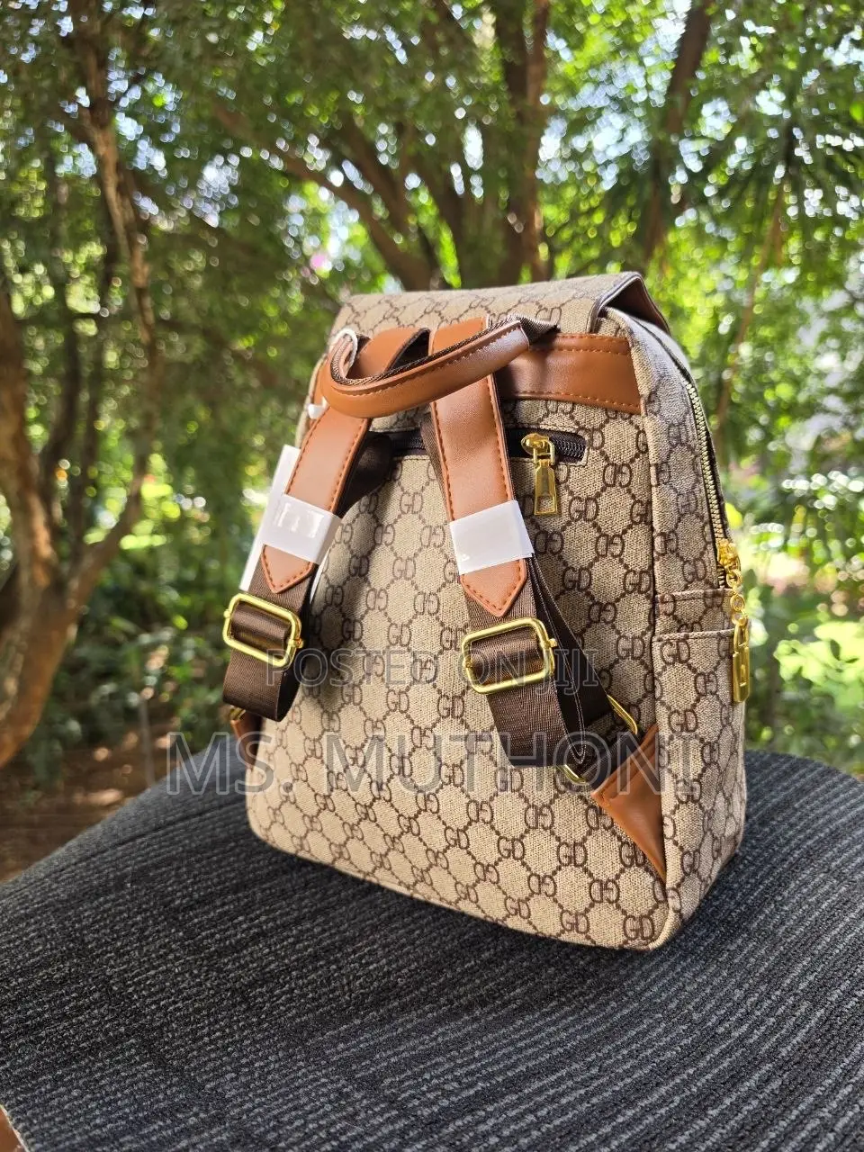 Retro-Style Unisex Backpack Features a Monogram Printed Material
