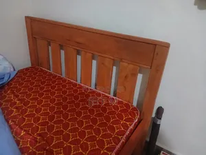 A Brown Hard Wood Bed, in Very Good Condition. Clean and Comfortable.