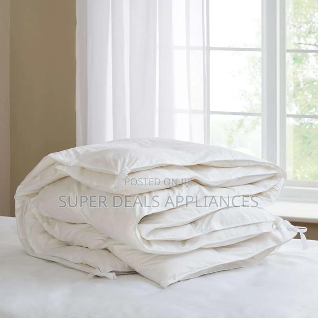 A Set of White Unbinded Duvet With a Bedsheet and Two Pillow Cases
