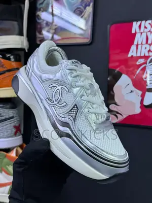 Chanel Trainers in White and Silver.