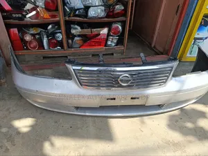 Bumper Front Nissan Ad Complete With Grill and Covers