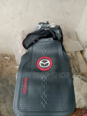 Floor Mats With Prominent Mazda Logo in a Red Circular Frame