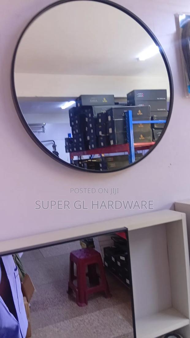 A Black Round Mirror With Black Metal Frame - main view