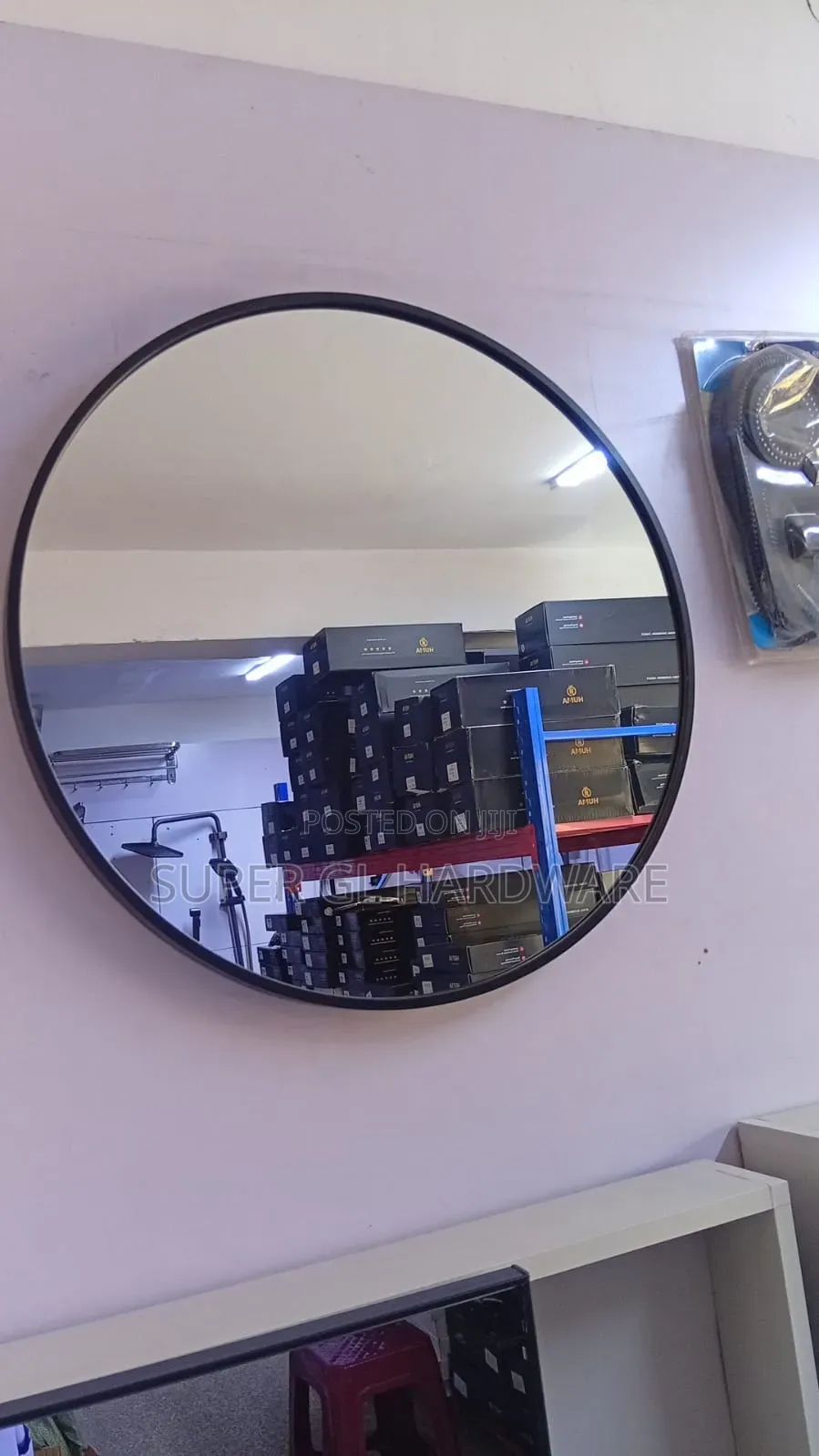 A Black Round Mirror With Black Metal Frame