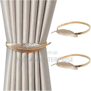 A Pair of Feather Shaped Elastic, Metallic Curtain Buckles *