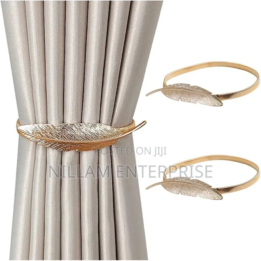 A Pair of Feather Shaped Elastic, Metallic Curtain Buckles *