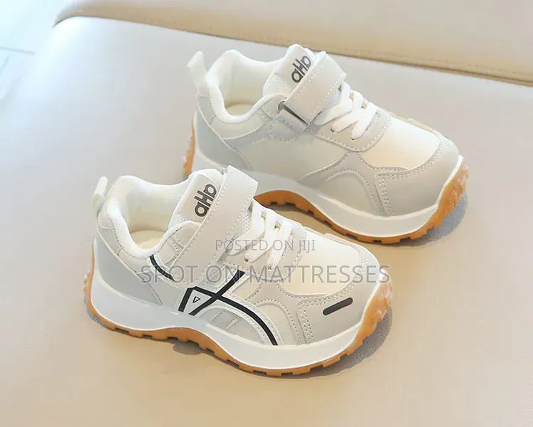 Children Sneakers in Colours White and Black. Delivery Available.