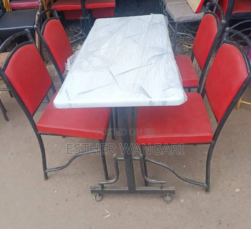 A Set of Four Red Chairs and White Table