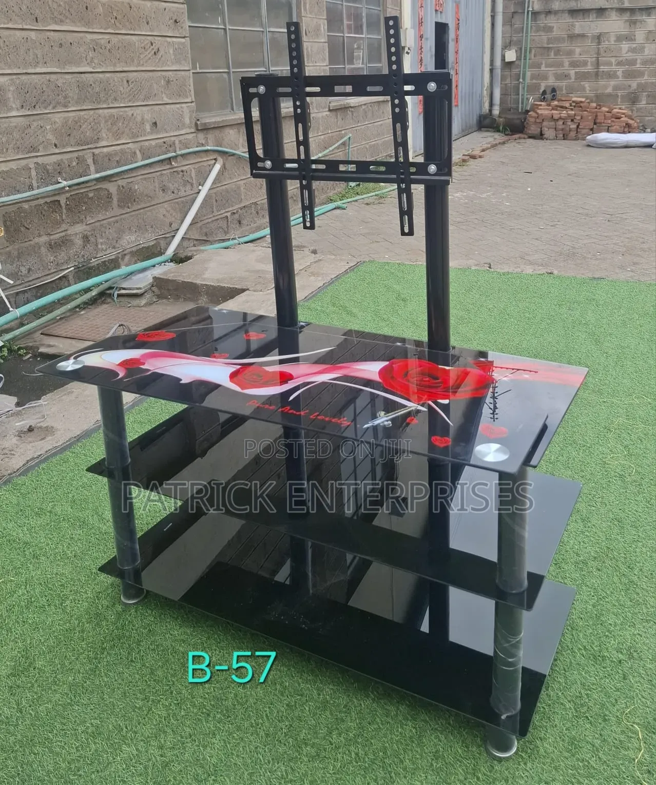 This 3-Tier Black Glass TV Stand With a Built-in Metal Mount Bracket