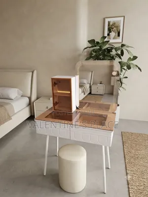 A Modern White Vanity Table With a Glass Top, Lighted Mirror