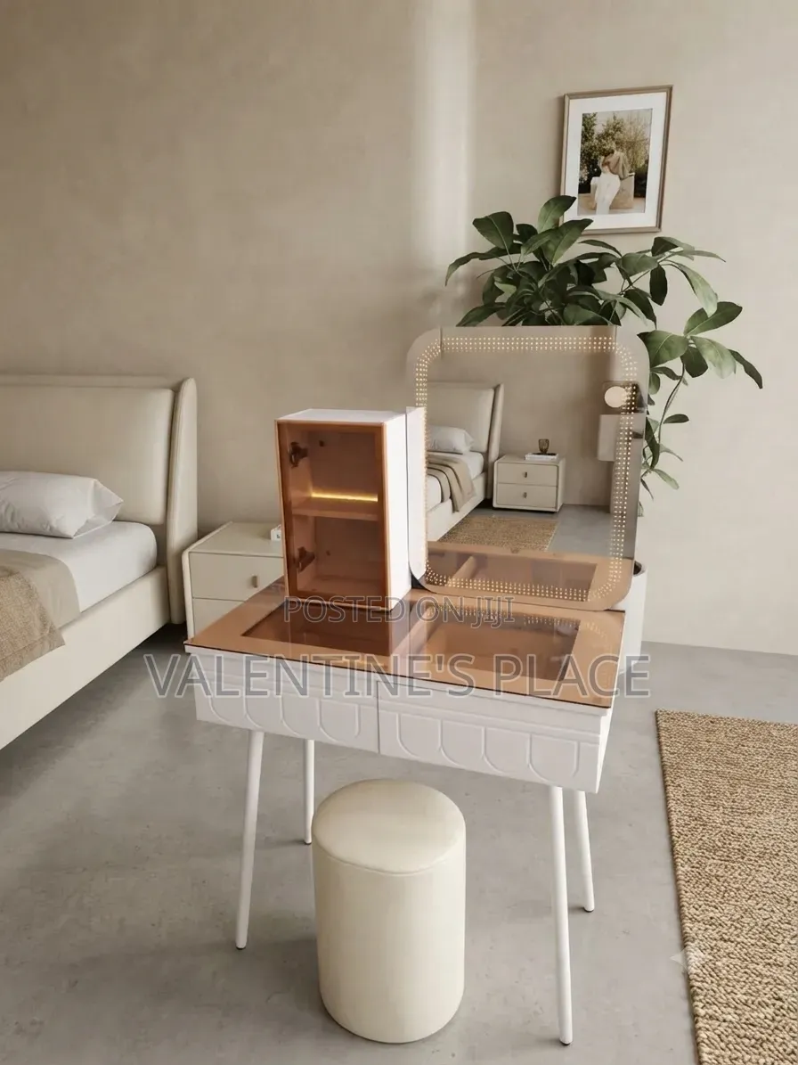 A Modern White Vanity Table With a Glass Top, Lighted Mirror