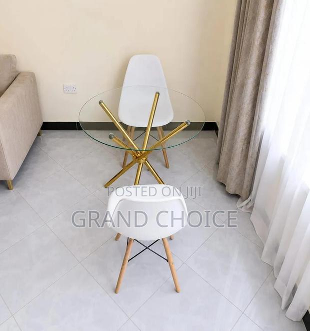 Modern Round Glass Dining Table Set With White Eames Chairs