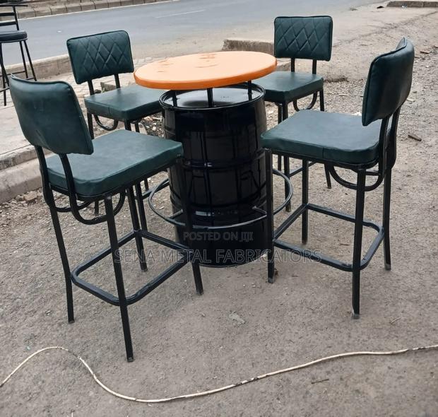 A Metal Drum Set With Green Bar Stools. - thumbnail 2