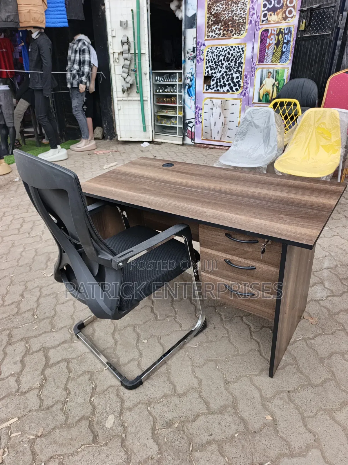 This Set of a Dark Walnut Desk Paired With a Black Mesh Chair.