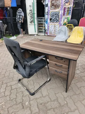 This Set of a Dark Walnut Desk Paired With a Black Mesh Chair.