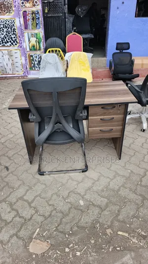This Set of a Dark Walnut Desk Paired With a Black Mesh Chair.