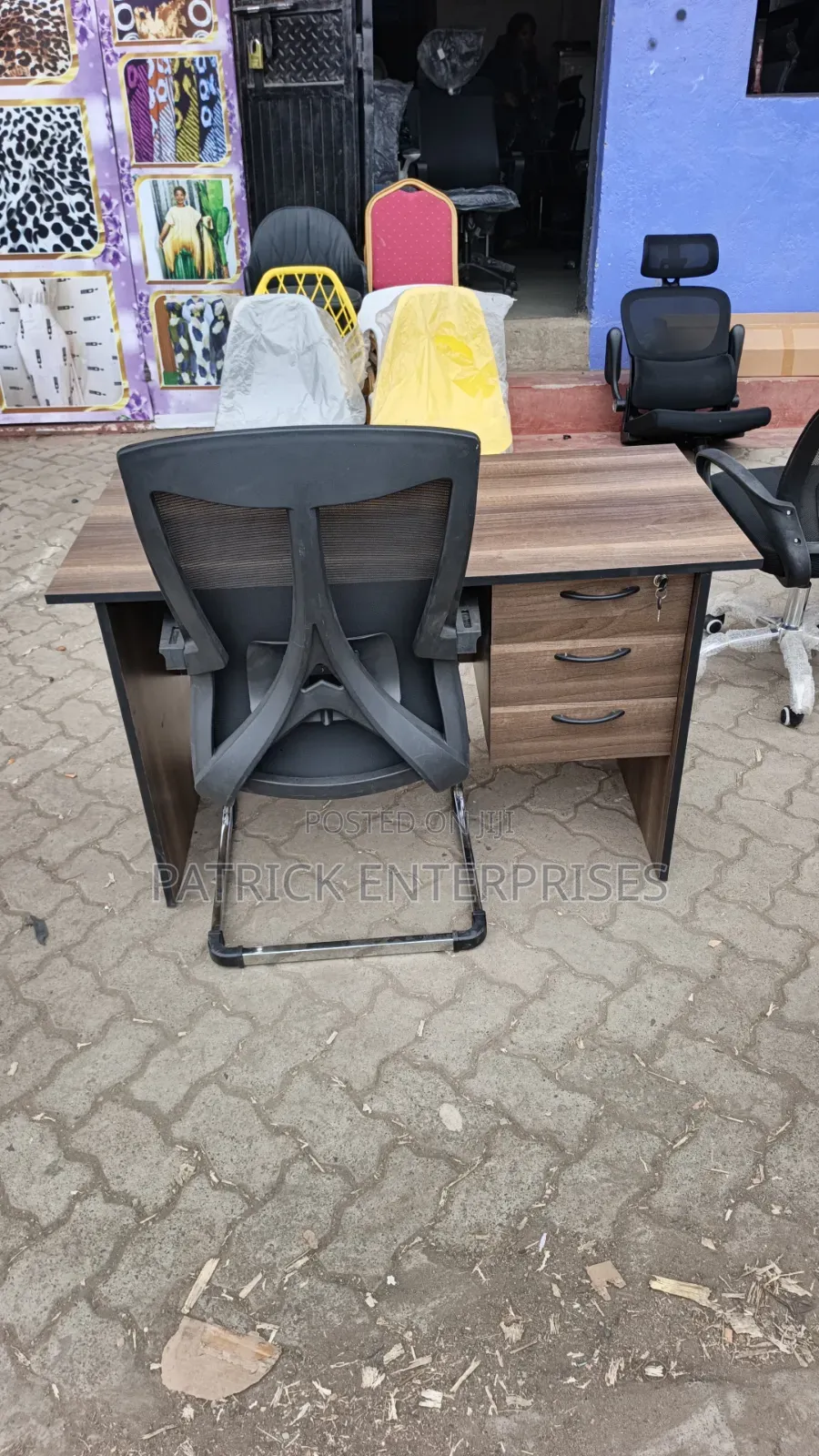 This Set of a Dark Walnut Desk Paired With a Black Mesh Chair.