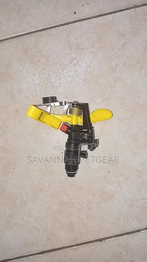 Plastic Impact Sprinkler Head Featuring a Yellow Rocker Arm.