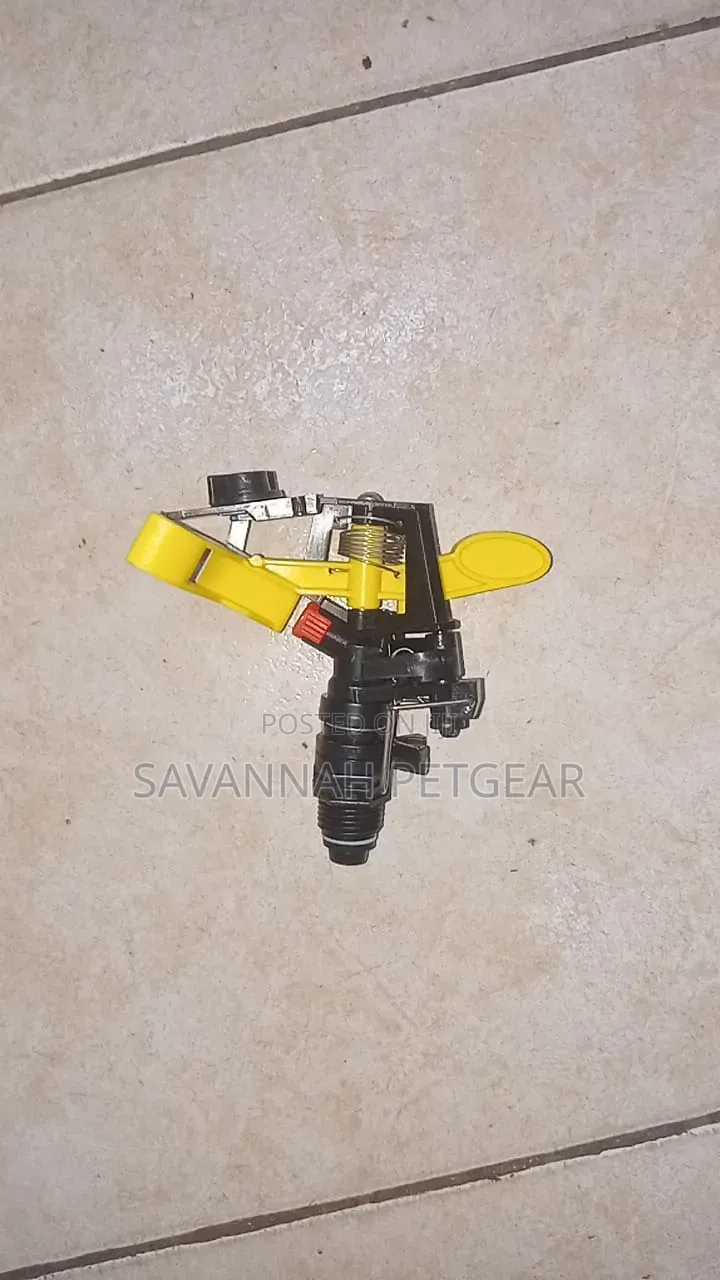 Plastic Impact Sprinkler Head Featuring a Yellow Rocker Arm.